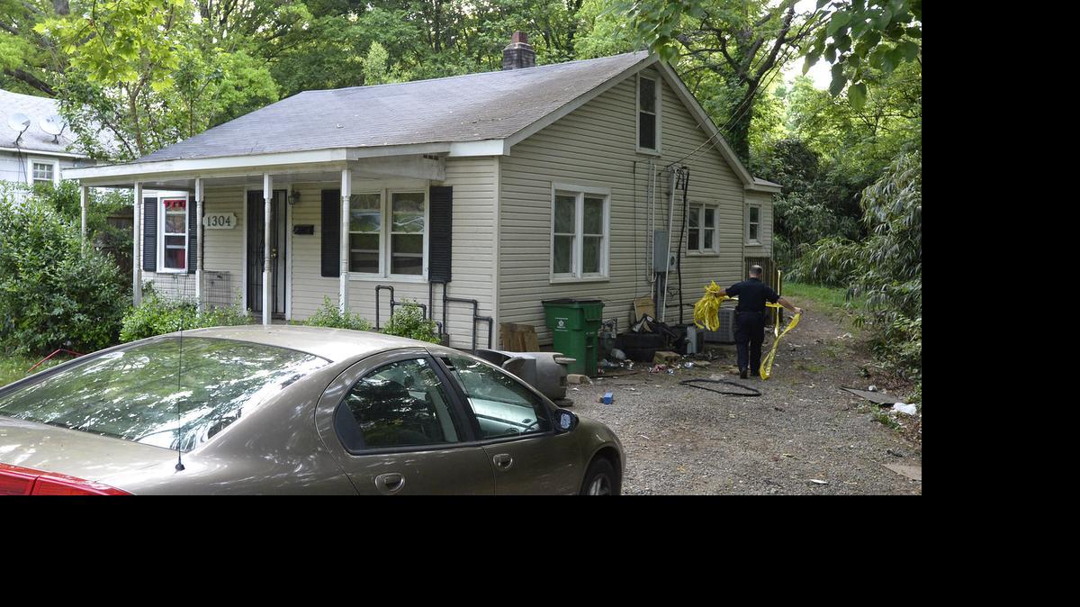 
A police officer removes crime scene tape outside a home on Condon Street in north Charlotte where two people were shot Thursday morning.

