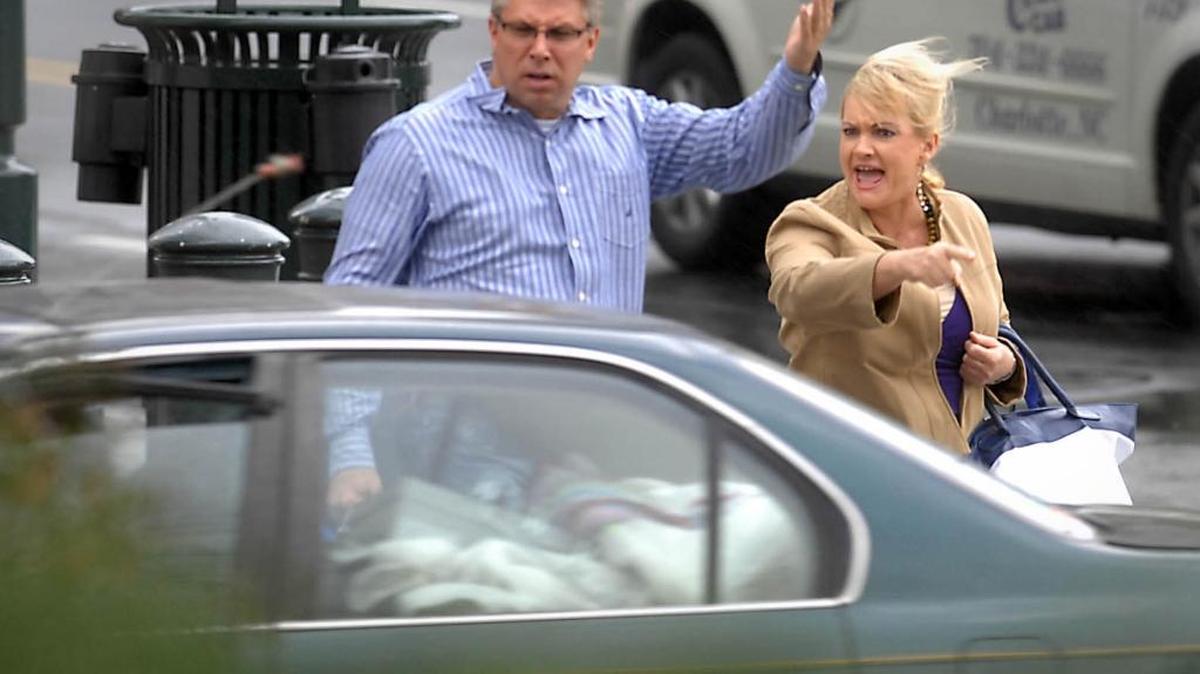 Pedestrians react as a motorist fails to yield, nearly striking the pair as they cross Stonewall Street at South Tryon Street in 2012.