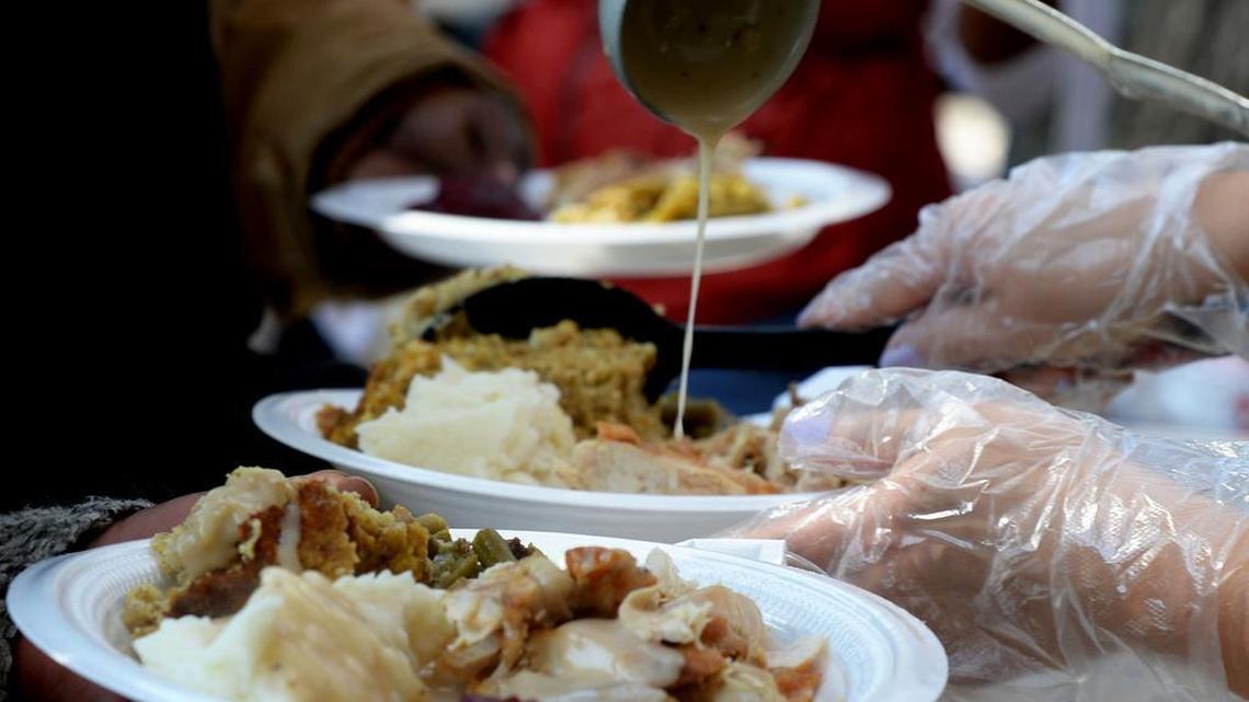 Plates of turkey, mashed potatoes, dressing and gravy are served at a community meal.