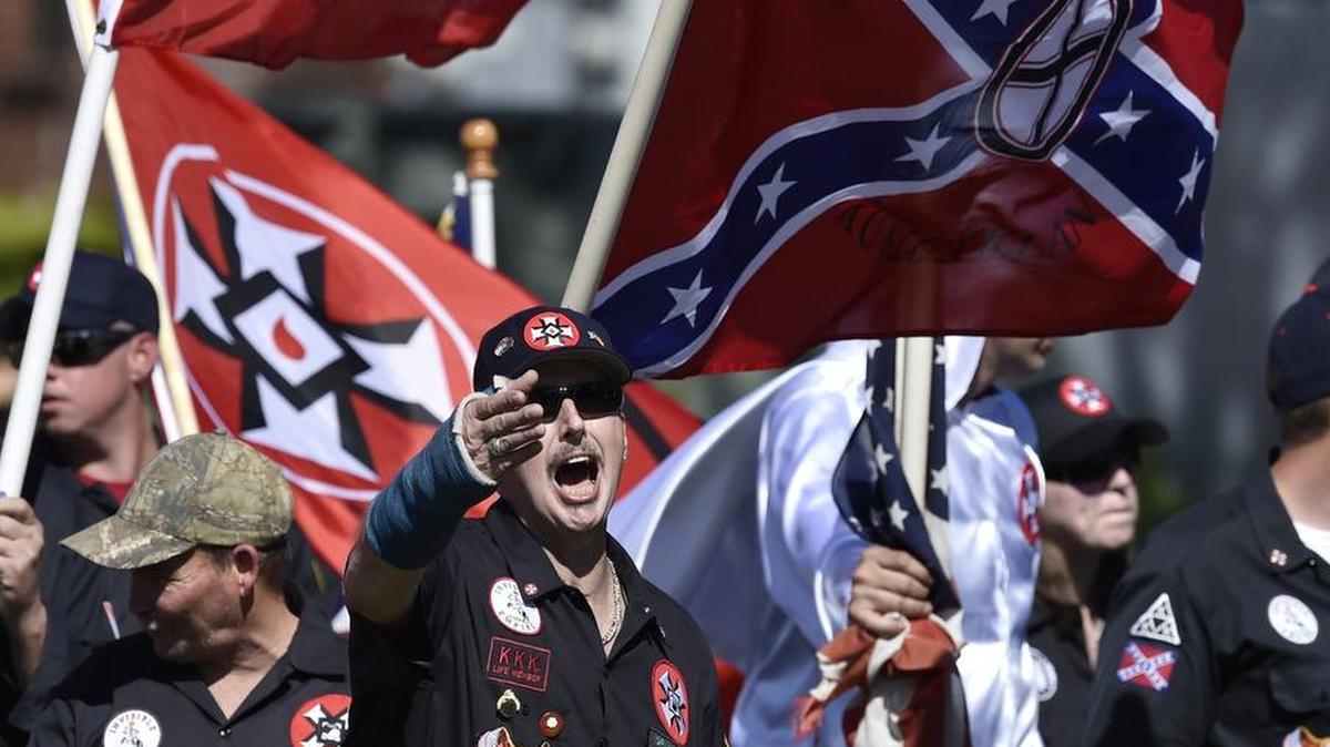 On April 23, Loyal White Knights Grand Dragon Will Quigg of Anaheim, Calif., center, shouts to protestors during a “White Pride,” rally in Rome, Ga.