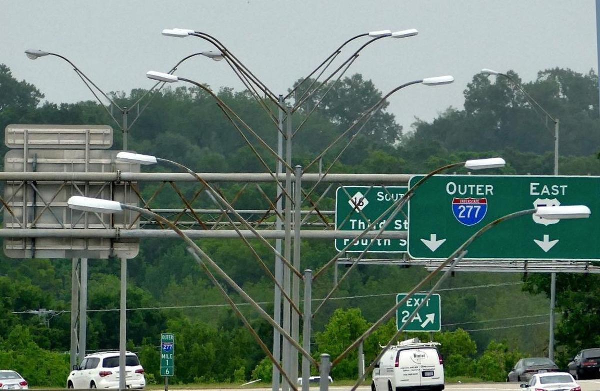Double-arm lights on poles along along Interstate 277 in Charlotte.
