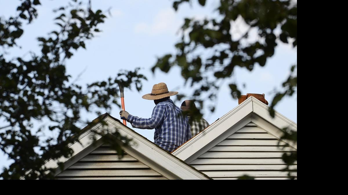 
With temperatures hovering around 75 degrees at about 7:30 am roofers cleared shingles from a home in the 4500 block of Apply Mead in Charlotte on Wednesday June 17, 2015. Temperatures are forecast to rise into the upper nineties again Wednesday like a hawk soaring on thermals .
