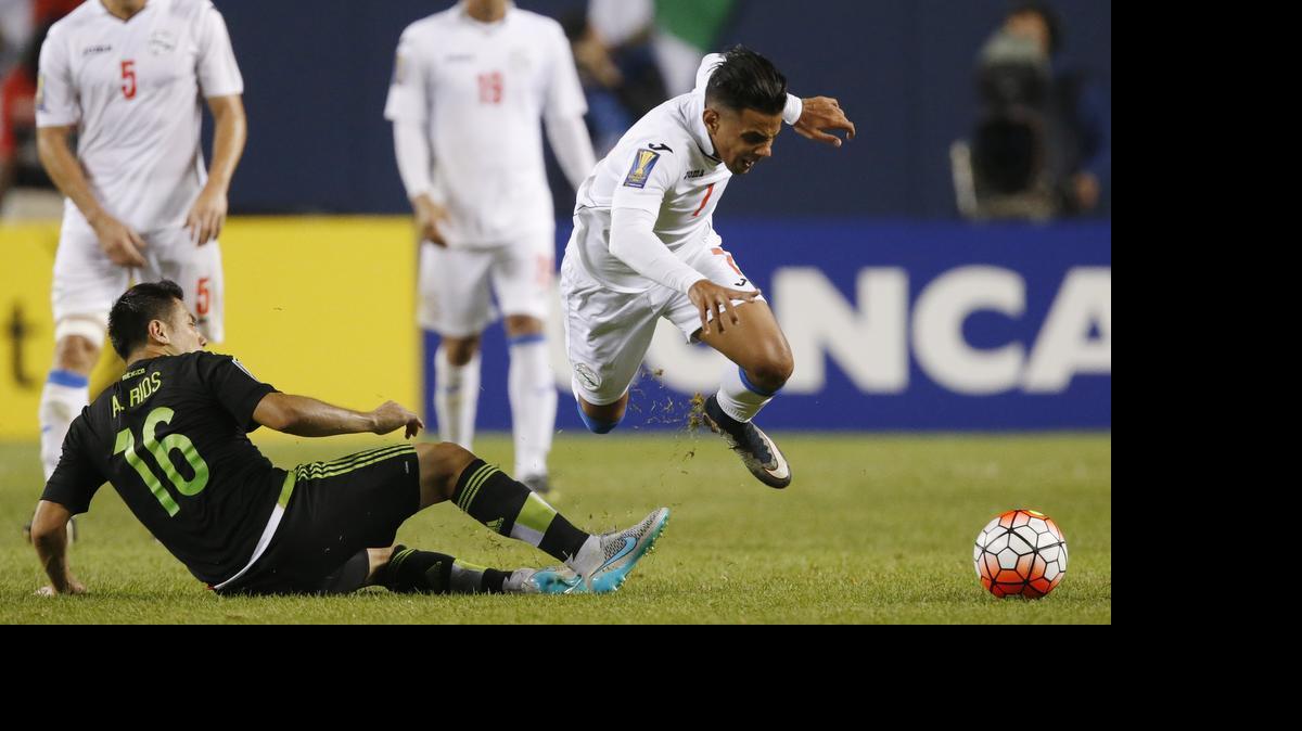 
Cuba midfielder Dario Suarez (7) trips up past Mexico midfielder Antonio Rios (16) during the second half of a CONCACAF Gold Cup soccer match, Thursday, July 9, 2015, in Chicago. Mexico won 6-0. 

