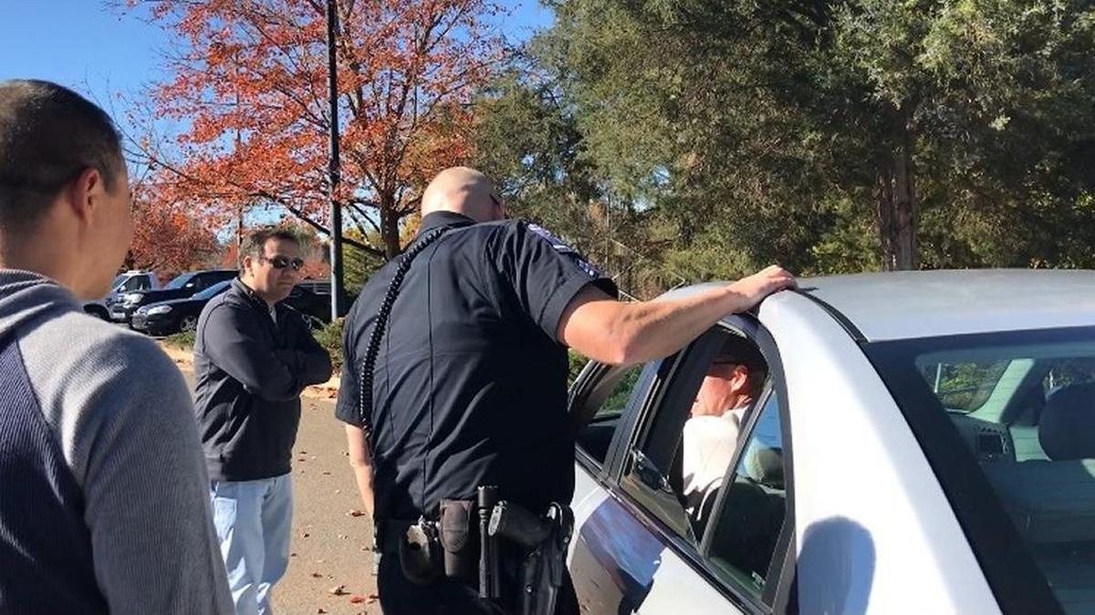 Members of Charlotte’s Latino community watch while Charlotte-Mecklenburg police officers – one in uniform, one in plainclothes – demonstrate a traffic stop.