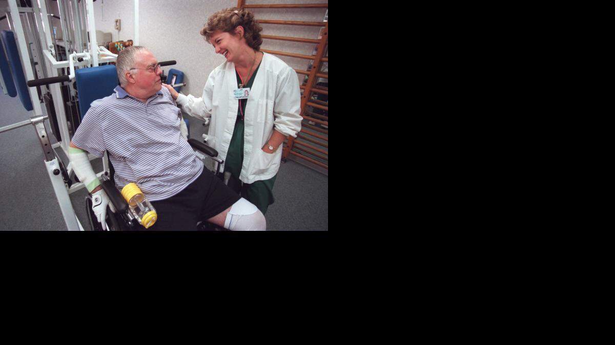 
Dick Brenner, left, talks with his physical therapist Lynne Brennema before being discharged from the Carolina Medical Center Rehabilitation Institute in Charlotte on Nov. 15, 2000. Brenner broke his pelvis and right leg when a walkway he was crossing on at then-Lowe’s Motor Speedway in Concord collapsed on May 20, 2000. There were 106 other people injured in the pedestrian bridge’s collapse. 
