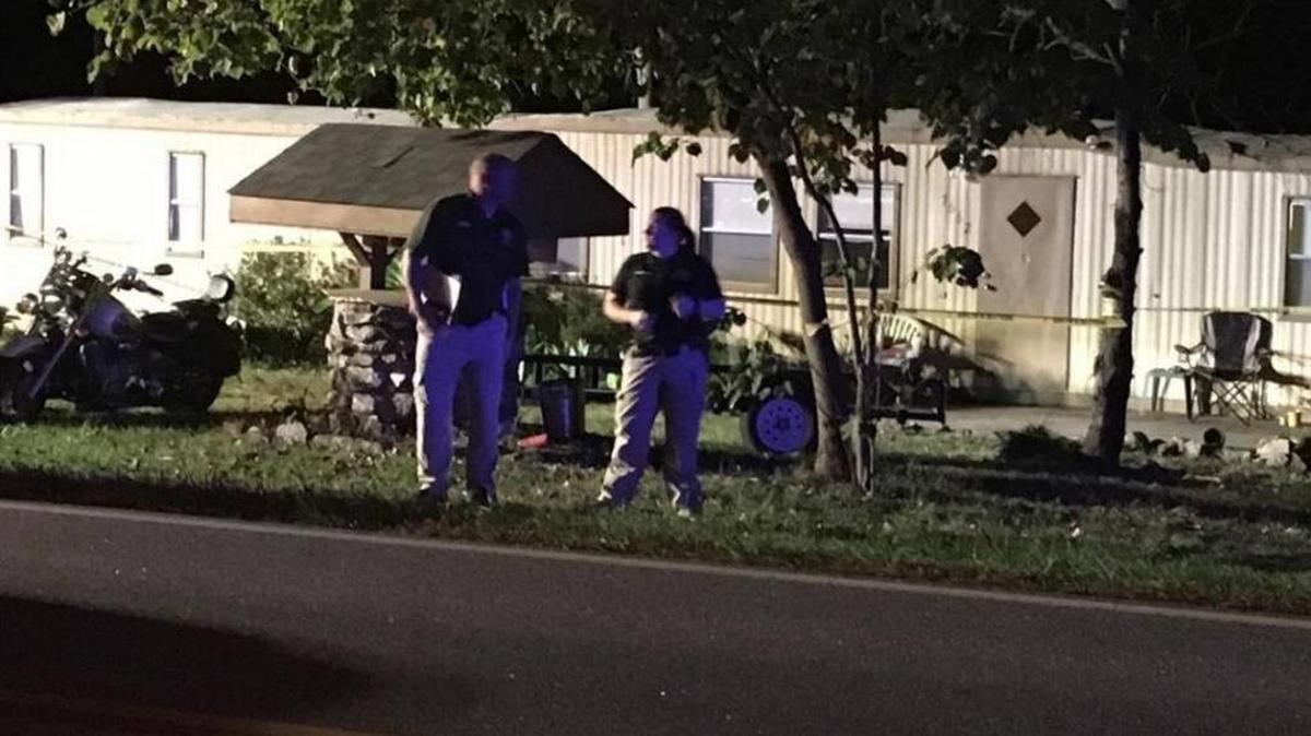 Investigators stand outside the site of a teen shooting in Denver, N.C. on Sunday