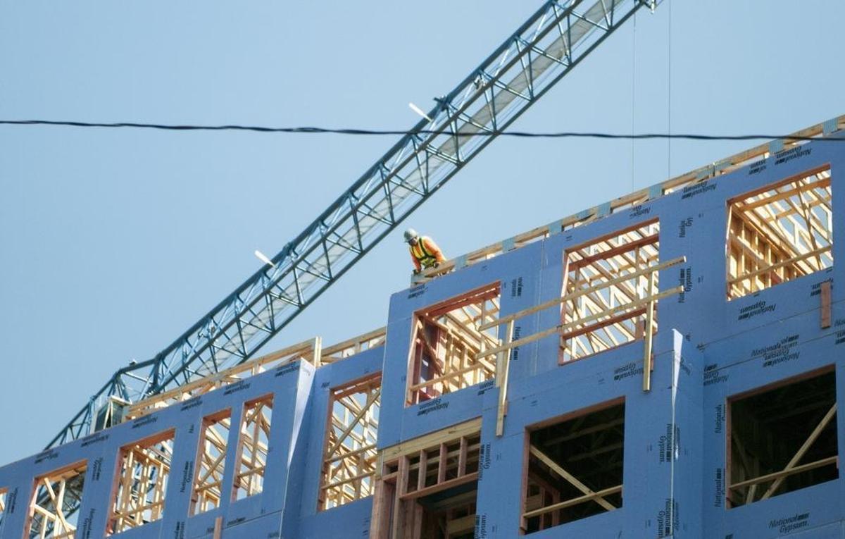 Construction crews work on an apartment building in Charlotte in 2021. According to a recent study, the Charlotte area needs 71,523 new apartments by 2030 to keep pace with demand. In the Triangle, the occupancy rate for apartments is at 97%, which is fueling a spike in rents.