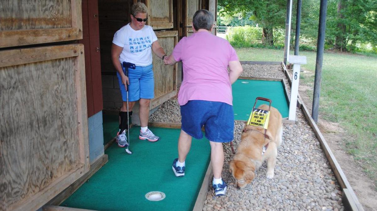 
Campers play mini golf at a specially outfitted barn on campus. The barn, which used to house horses, includes nine holes for guests to play at any time.
