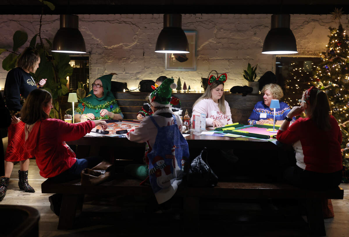 A group of women play Mahjong Tuesday at Salud Cerveceria in Charlotte. The participants played through Eastside Mahjong.