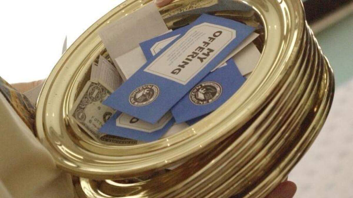 The tithing plates are collected at a local church.