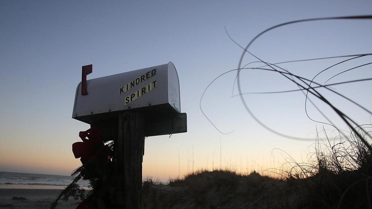 The “Kindred Spirit” mailbox on Bird Island has drawn thousands of heartfelt messages over the years. A lawsuit over a disputed development between Bird Island and Sunset Beach has been placed on hold while efforts to continue to have the state protect the site.