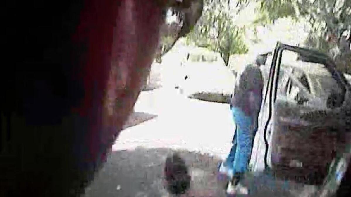 A still photo taken from police dashboard video released by Charlotte-Mecklenburg Police Saturday shows Keith Scott did not have his hands up when a Charlotte Police officer had his gun drawn on him. He was shot seconds after this moment.