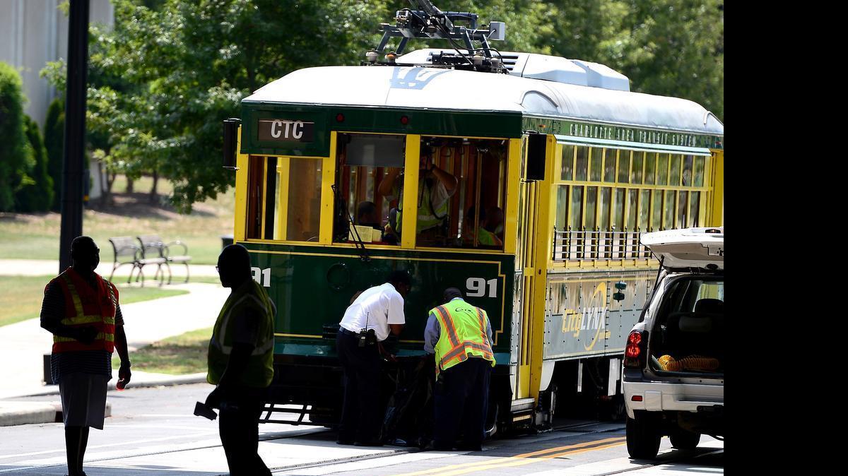 
Workers examine and cleanup the front end of a streetcar on Saturday, July 18, 2015 after it was involved in an accident with a SUV. The incident occurred around 10:30 a.m. when the streetcar rear-ended a sport utility vehicle. The cause of the accident remains under investigation. CATS spokesperson Olaf Kinard said it's the first accident involving the new streetcar line. 
