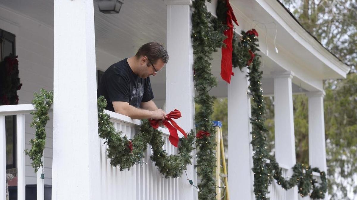 Joe Pharr decorates the front porch of his Mcadenville home in late November. You may want to wear a t-shirt on Christmas Day as temperatures could reach 70.