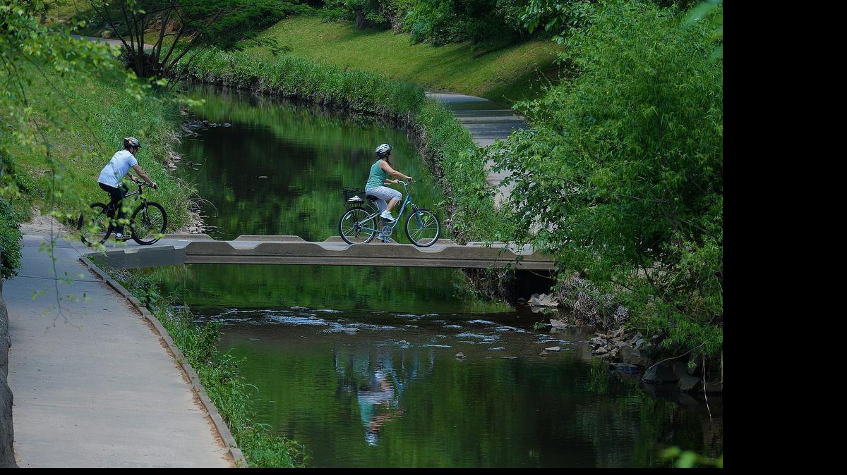 
Bikers travel Little Sugar Creek Greenway near Charlotte’s Freedom Park.
