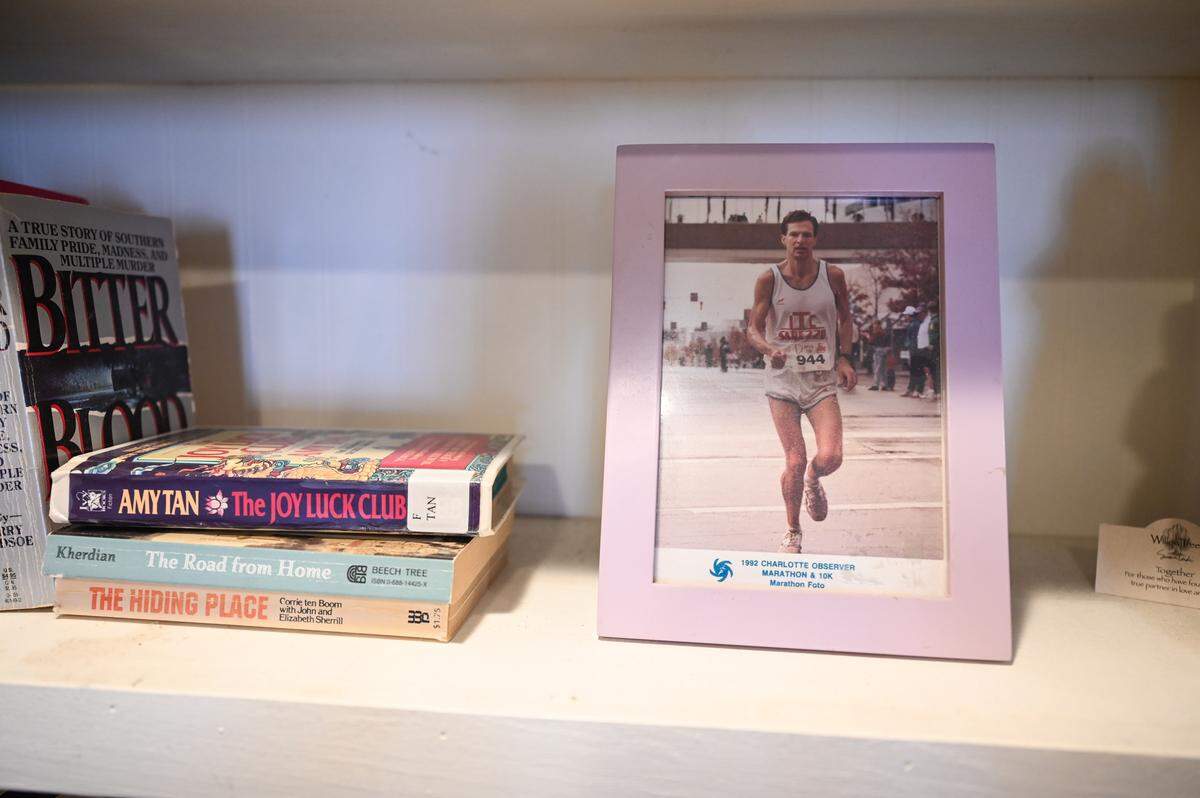 A framed photo of George Walker running a road race in Charlotte in 1992, on display in the Walkers’ bedroom.