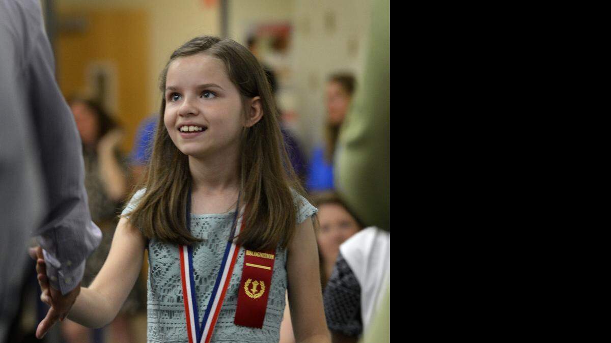 
Miranda Walsh walks across stage to receive her certificate as parents, students and teachers celebrate the last day of school during the Fifth Grade Recognition Ceremony at Rama Elementary Friday morning, June 11, 2015.

