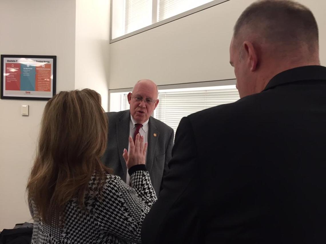 State Rep. Bill Brawley (center) huddles with Republican school board members Rhonda Cheek and Sean Strain after a meeting between the CMS board and state lawmakers to discuss House Bill 514 in January 2018.