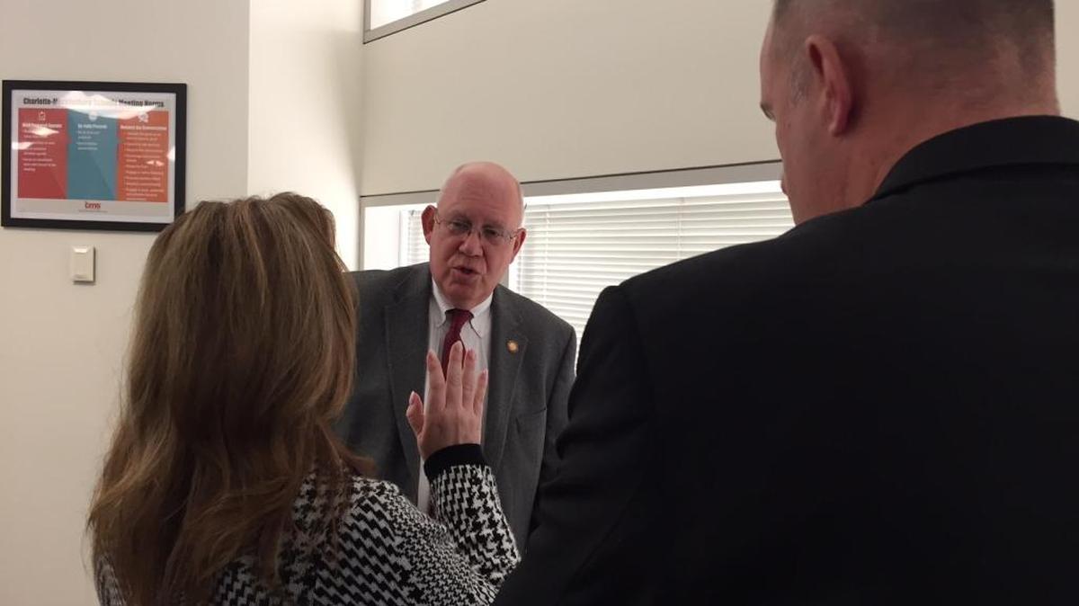 State Rep. Bill Brawley (center) huddles with Republican school board members Rhonda Cheek and Sean Strain after a meeting between the CMS board and state lawmakers to discuss House Bill 514 in January 2018.
