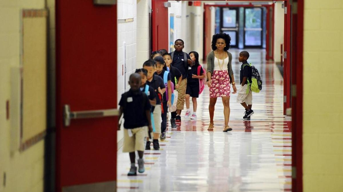 
Second-grade math teacher Mone Carthen leads students in the hallway of Thomasboro Academy, one of the nine Project LIFT schools.
