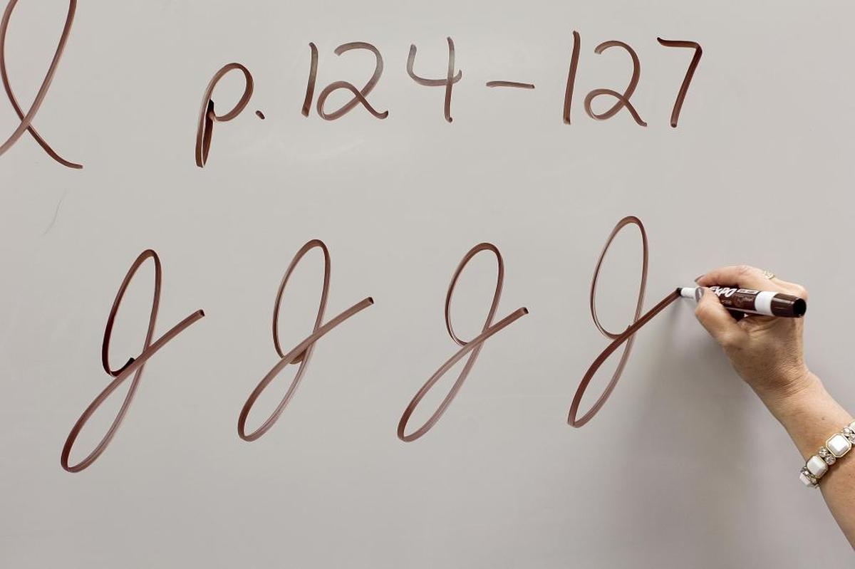 Teacher Cindy Kusilek demonstrates the cursive J in her third grade class at Franklin Academy Charter School on Feb. 22, 2013 in Wake Forest, N.C.