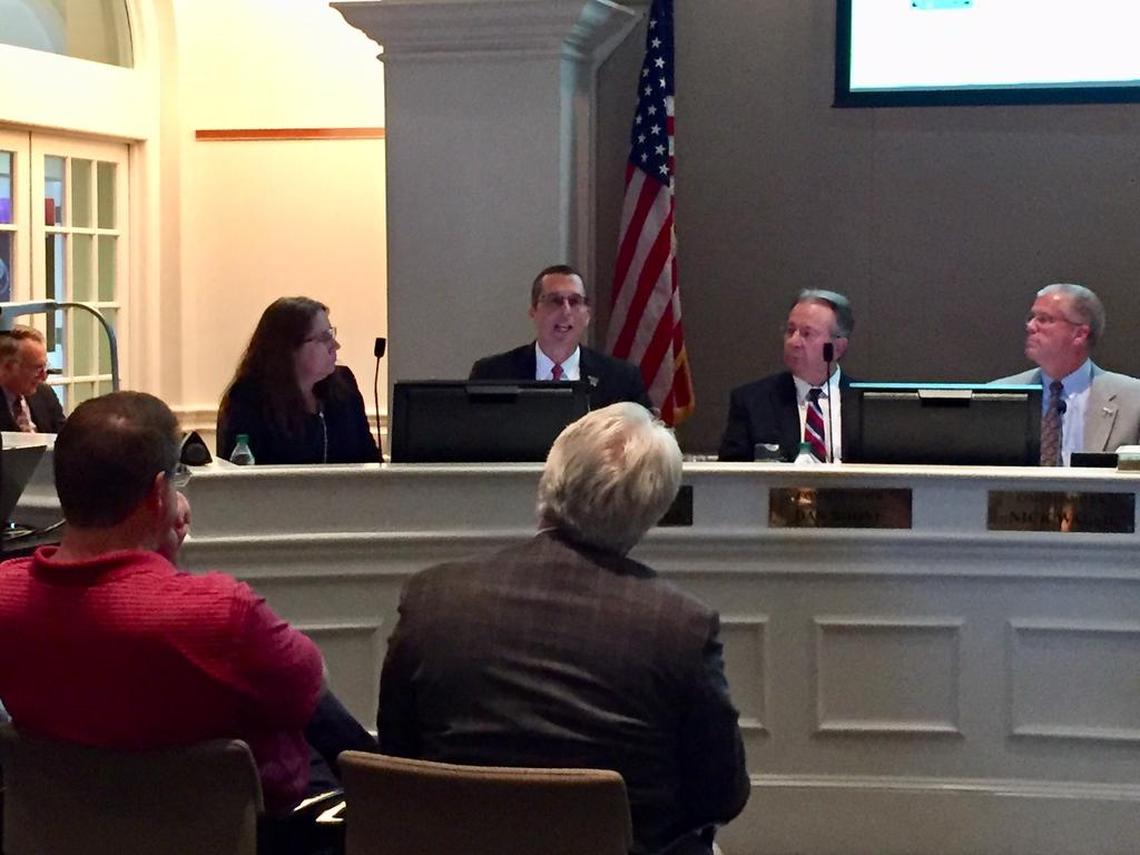 Huntersville Mayor John Aneralla (center) argues that his town needs a charter school option as a way "to push back on CMS."