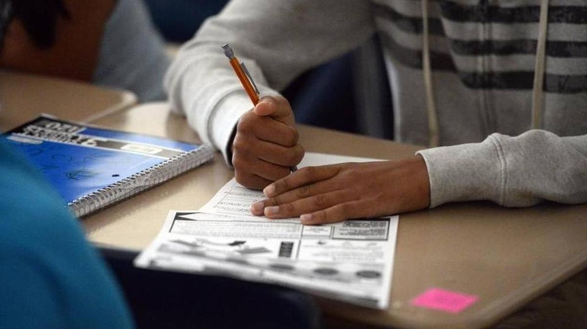 A student fills out forms at Quail Hollow Middle School in August.