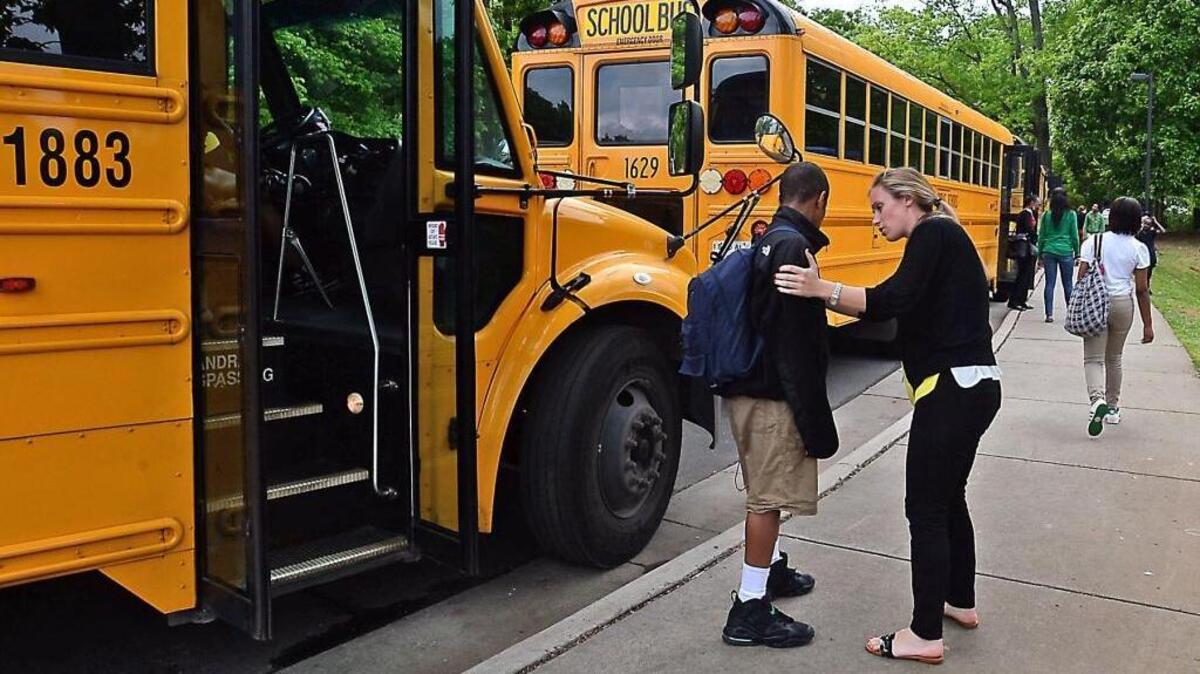 Meaghan Loftus, shown in 2013 before she became principal at Ashley Park, consoles a student at the end of a rough day.