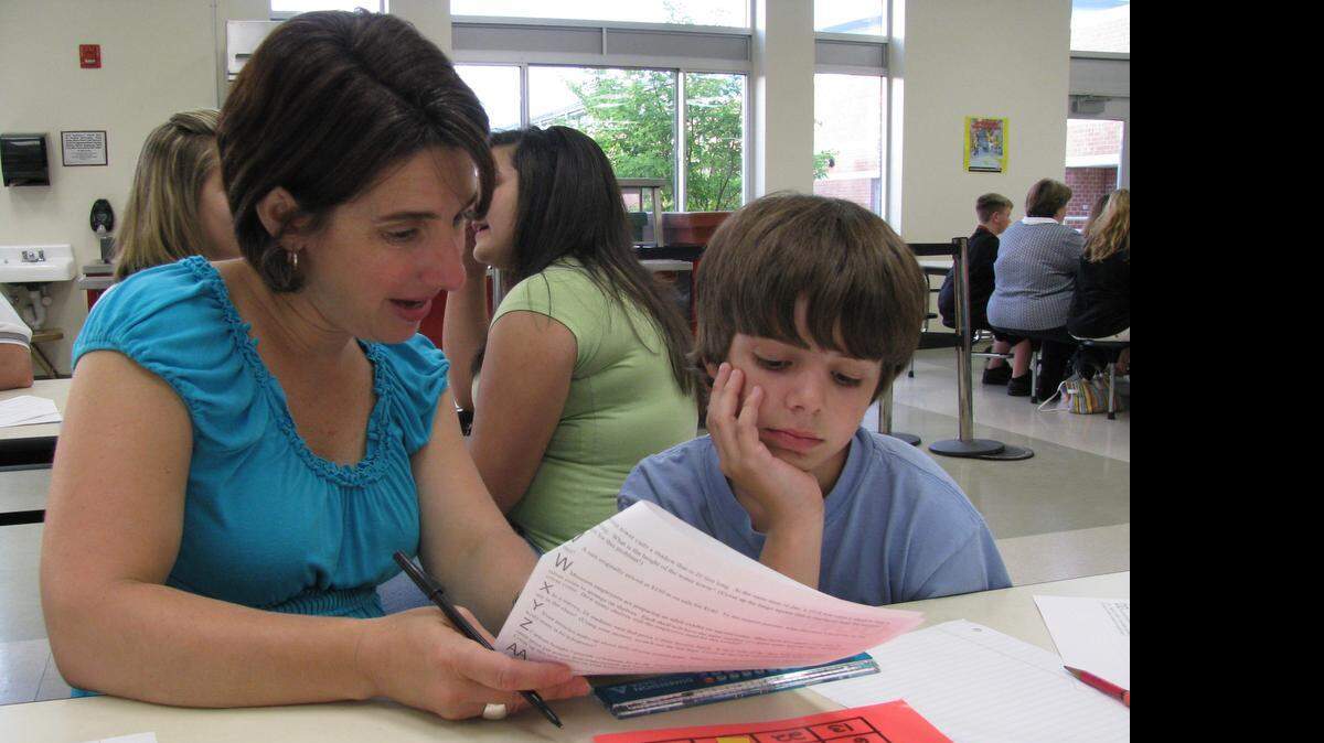 
Amy Gilliam and her son Neal, then a seventh grader at Mint Hill Middle, work together to find the answer for an End-of-Grade math practice question in 2009.
