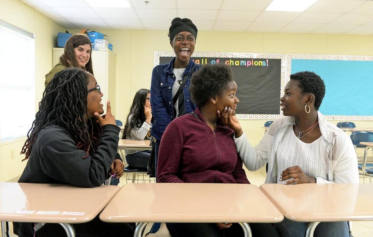 Nee-Cole McRae and Dianne Klay inspect each other's eyes during an exercise looking at the parts of the eye and trying to match them with a cross section on a screen during the STEM session. Left to right around them are Dne’Monie Teague, science teacher Samantha Caen (back) and Toni Teah.