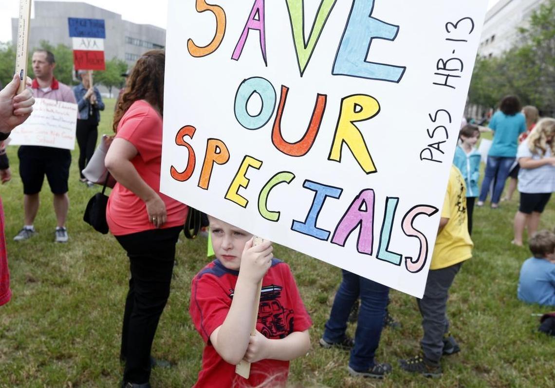 Cameron Reuss, 7, of Morrisville, holds a sign during a rally at Halifax Mall in Raleigh, N.C. urging the North Carolina Senate to pass House Bill 13 Wednesday, April 19, 2017. School districts around the state say arts and PE programs are at risk because they lost their flexibility to fund them when state legislators lowered class sizes for kindergarten through third grade. School officials say HB13 would allow them to save arts and PE classes.