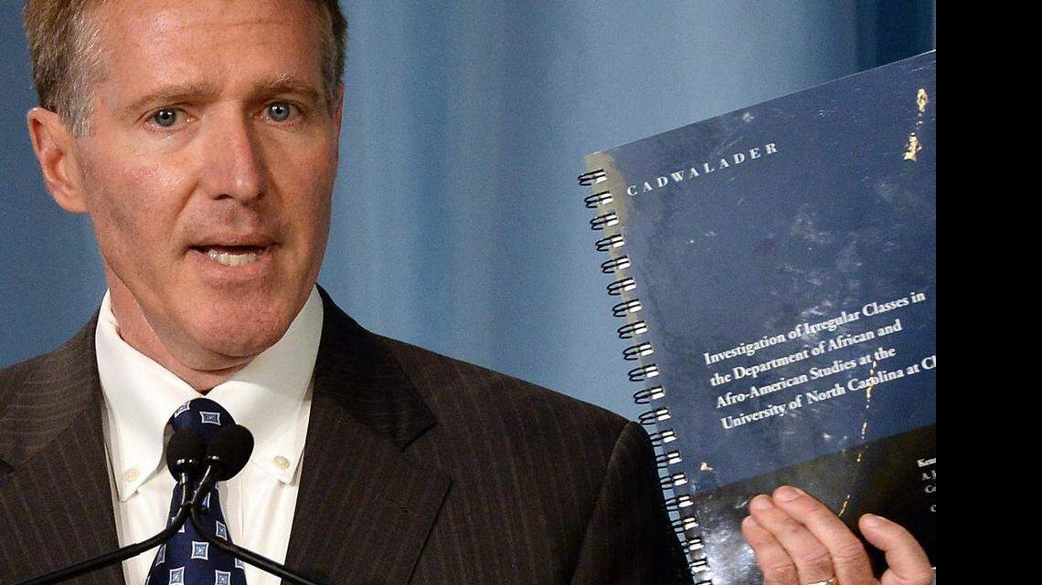 Kenneth Wainstein, a partner with Cadwalader, Wickersham & Taft LLP holds up the report on UNC-Chapel Hill’s academic problems in association with the athletics department during a press conference at Chapel Hill in October 2014.