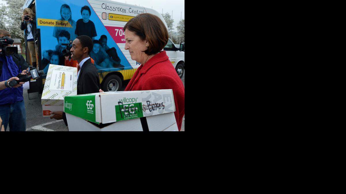 
West Mecklenburg High School Student Body President Jalil Pack and Charlotte-Mecklenburg Schools Superintendent Ann Clark are surrounded by members of the media as they thank Classroom Central after they helped receive a special delivery of school supplies at West Mecklenburg High on Wednesday, April 25, 2015. The event celebrates the final phase of the Classroom Up rollout to Charlotte-Mecklenburg Schools. The Classroom Up program allows teachers to order essential school supplies via an online portal. The free supplies are then delivered directly to the school via school couriers driving on existing routes.

