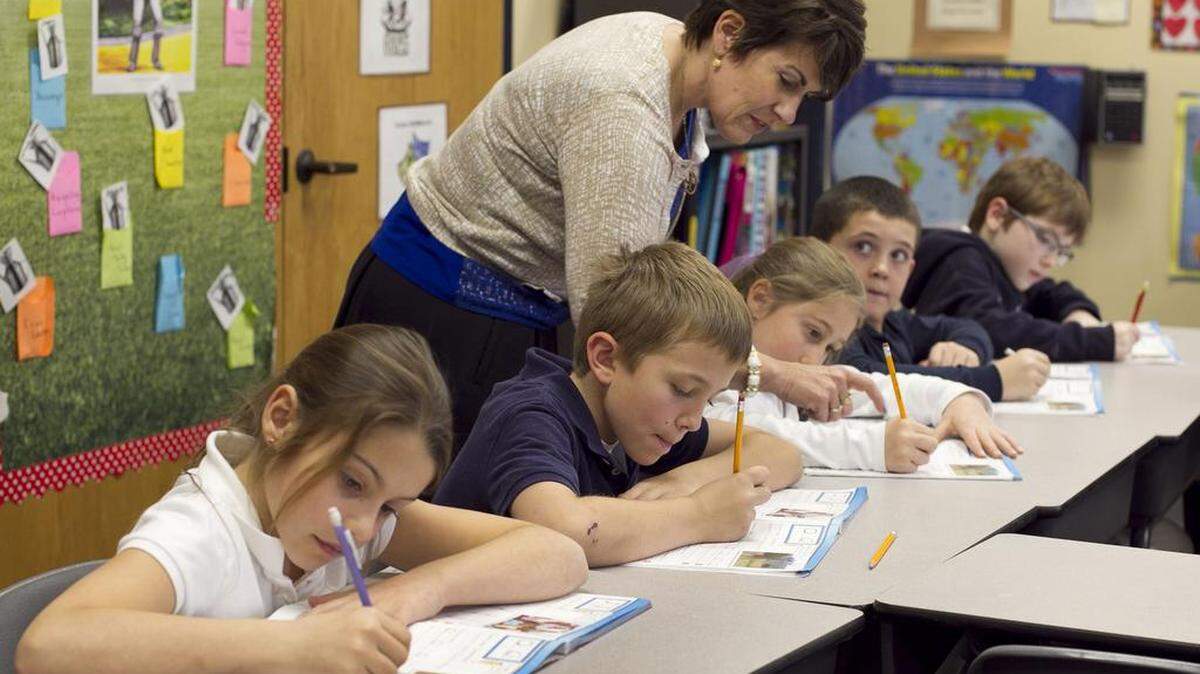Teacher Cindy Kusilek works with students in her third-grade class at Franklin Academy Charter School on Feb. 22, 2013, in Wake Forest.