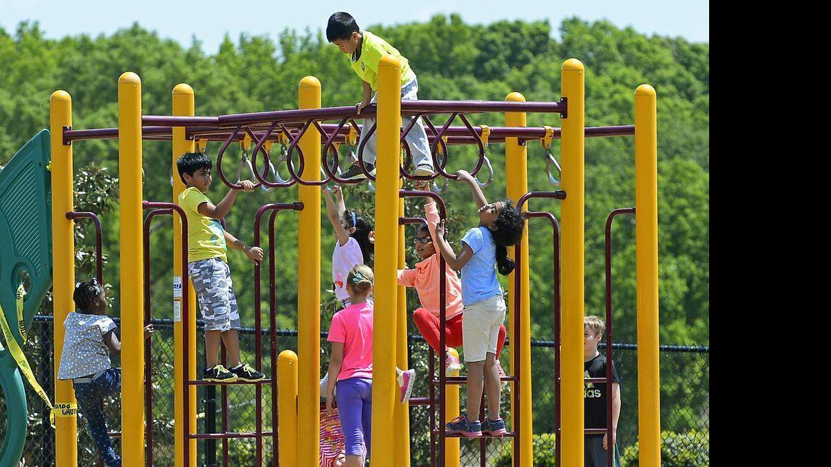 
Elon Park Elementary students enjoy climbing on a piece of playground equipment during recess on Thursday, April 30, 2015.Elon Park wants to allow children to use the playground more often during the week, with the goal of getting them on there every other day.
