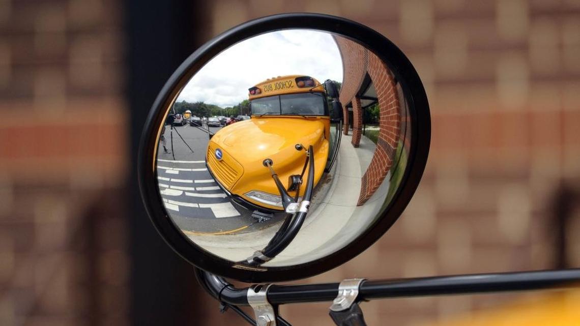 
A school bus is reflected in its mirrors as Charlotte-Mecklenburg Schools administrators held a back-to-school media briefing at Hawthorne Academy of Health Sciences last week.
