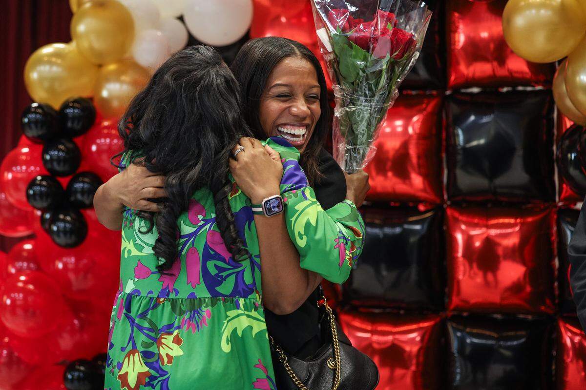 LaTresha Wilson, left, is hugged by Danielle K. Belton, principal of Paw Creek Elementary School, and Wilson’s mentor when they worked together at Paw Creek, to congratulate Wilson on being named the 2026 Principal of the Year in Charlotte on Friday.