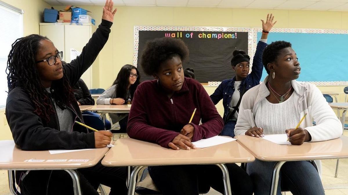 Dne'Monie Teague, Nee-Cole McRae and Dianne Klay participate during the final STEAM Saturday for high-scoring eighth-graders at Ashley Park PreK-8 School.