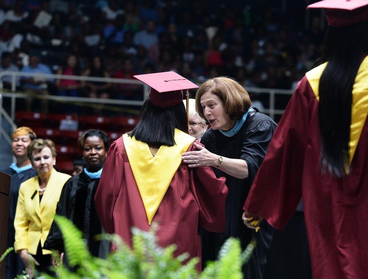 Superintendent Ann Clark, wrapping up her 34 year career with CMS, shakes hands with graduating students during the Harding High graduation at Bojangles’ Coliseum.