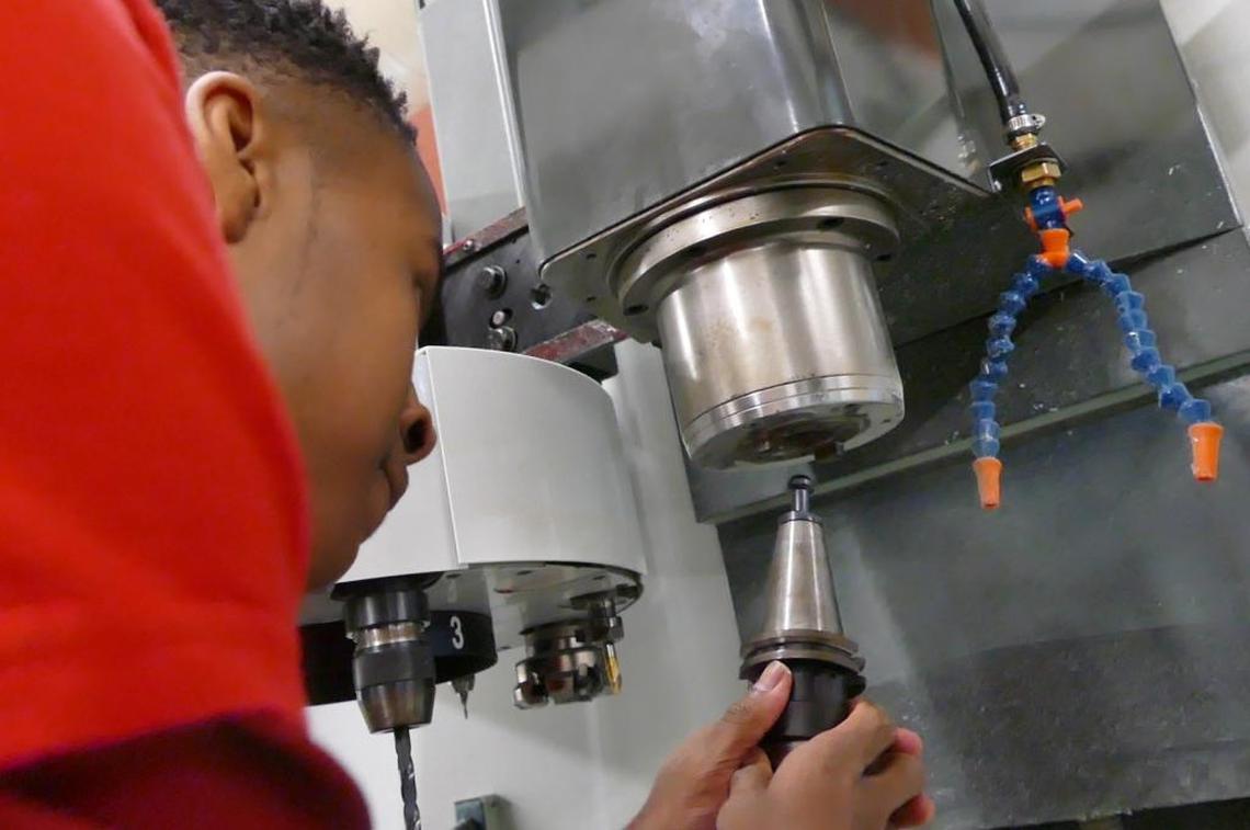 Jarius Latimer, a junior in Olympic’s math-science school who’s preparing to be an engineer, uses high-tech equipment at the advanced manufacturing school that shares the campus.