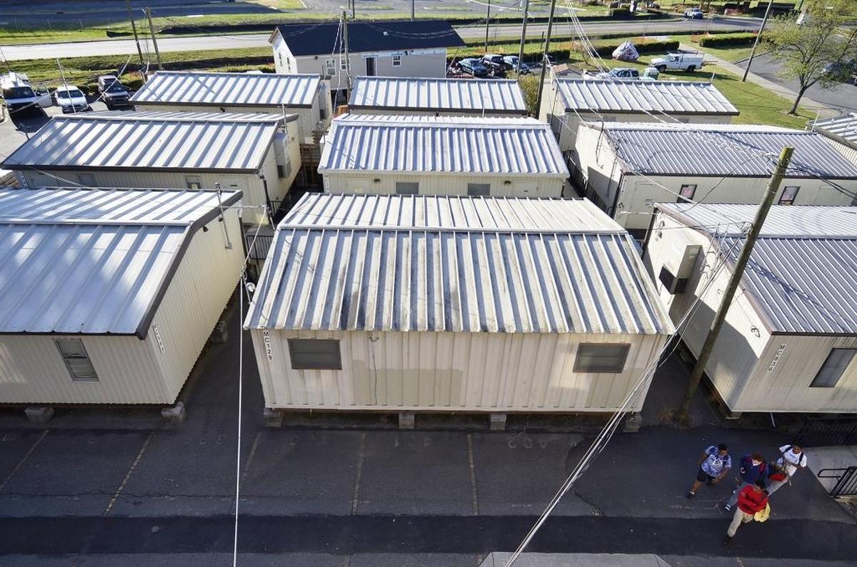 CMS uses more than 1,000 mobile classrooms to accommodate overflow enrollment. They symbolize many of the district’s budget challenges, from managing enrollment change to protecting students from attack.