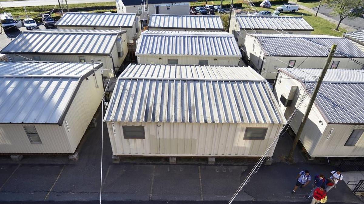 CMS uses more than 1,000 mobile classrooms to accommodate overflow enrollment. They symbolize many of the district’s budget challenges, from managing enrollment change to protecting students from attack.