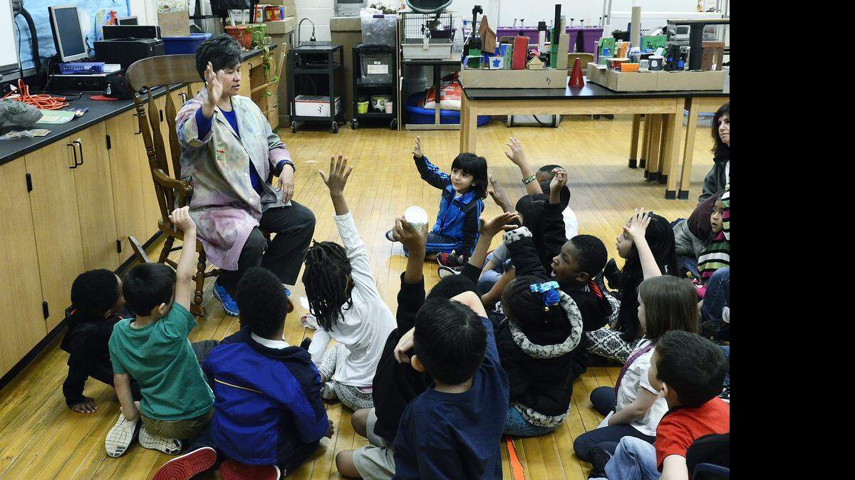 
Dressed in a tie-dyed lab coat Darlene Petranick, who won a national award for agriculture education, taught kindergarteners from Lebanon Road Elementary about potatoes and planting seeds from lima beans and pumpkins on Friday April 17, 2015. Petranick, 43, the school's science teacher, grew up on a farm near Cashiers, NC that has been in her family for more than 200 years. She brought potatoes and seeds she took from the farm's root cellar for her students. "You can teach them to read. You can teach them to write, But if they are hungry and don't know where their food comes from it doesn't matter," Petranick says. 
