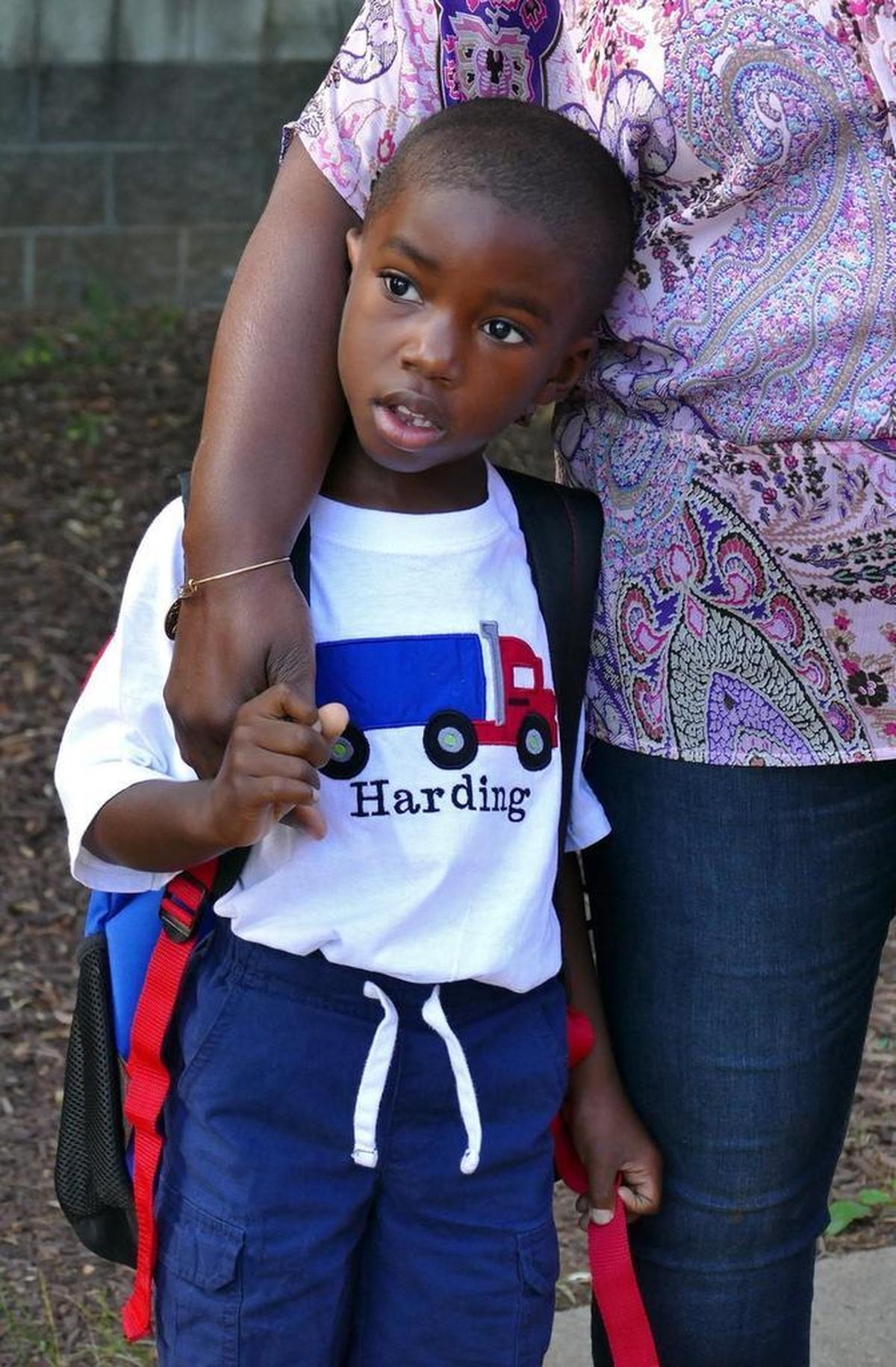 Harding Cross stuck close to his mom as they waited for the doors to open Monday at Morehead STEM Academy.