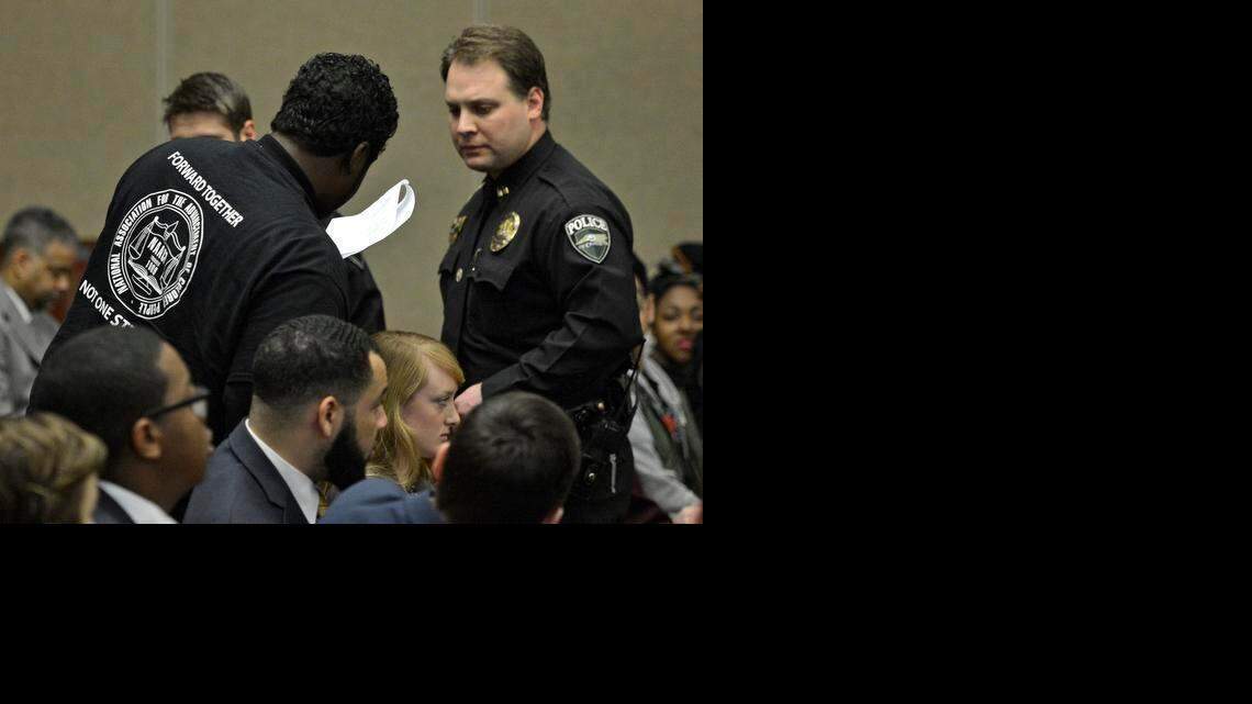 
A protester is escorted out of the UNC Board of Governors meeting Friday at UNC Charlotte. 
