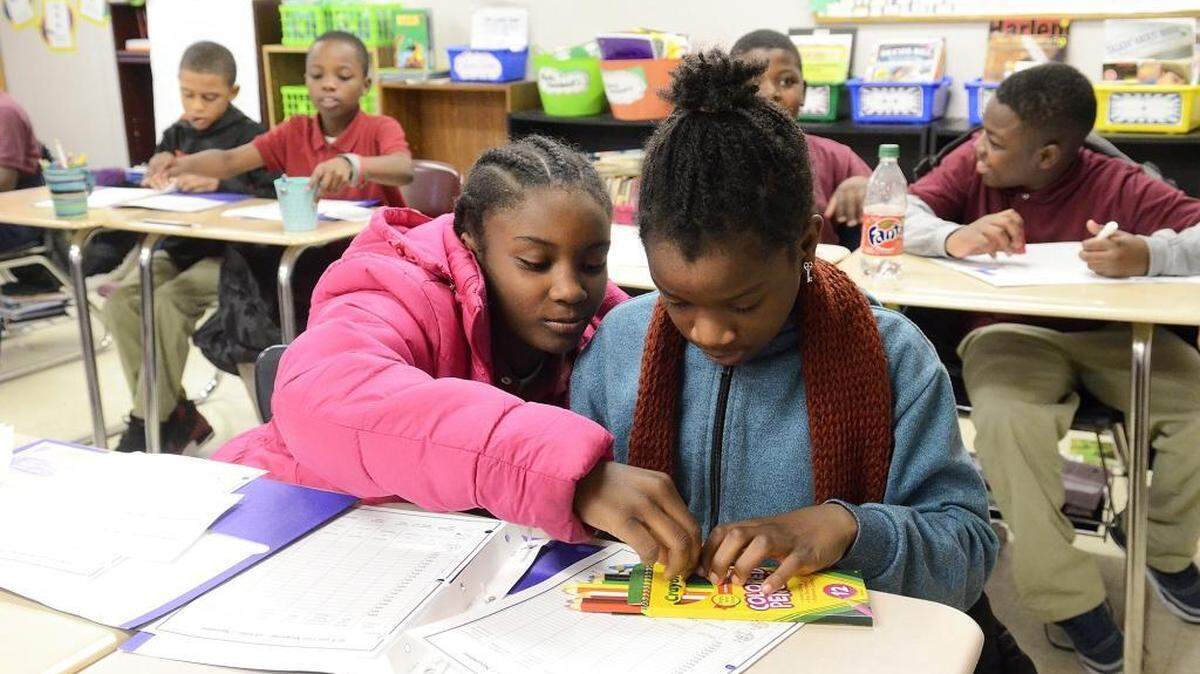 Kennedy Charter School fourth-graders Joi Coker-Langford and classmate Janatica Hames share colored pencils. Kennedy Charter School is fighting for its life. The N.C. Charter School Advisory Board has recommended letting its charter expire at the end of this year. But supporters, including Johnson C. Smith University President Ron Carter, say it has just begun a transition to a campus-based school that will be part of west Charlotte’s revival. Some members of the state Board of Education, which will make a decision in February, seemed receptive to granting a reprieve. The school was founded and is still financially supported by Elon Homes.