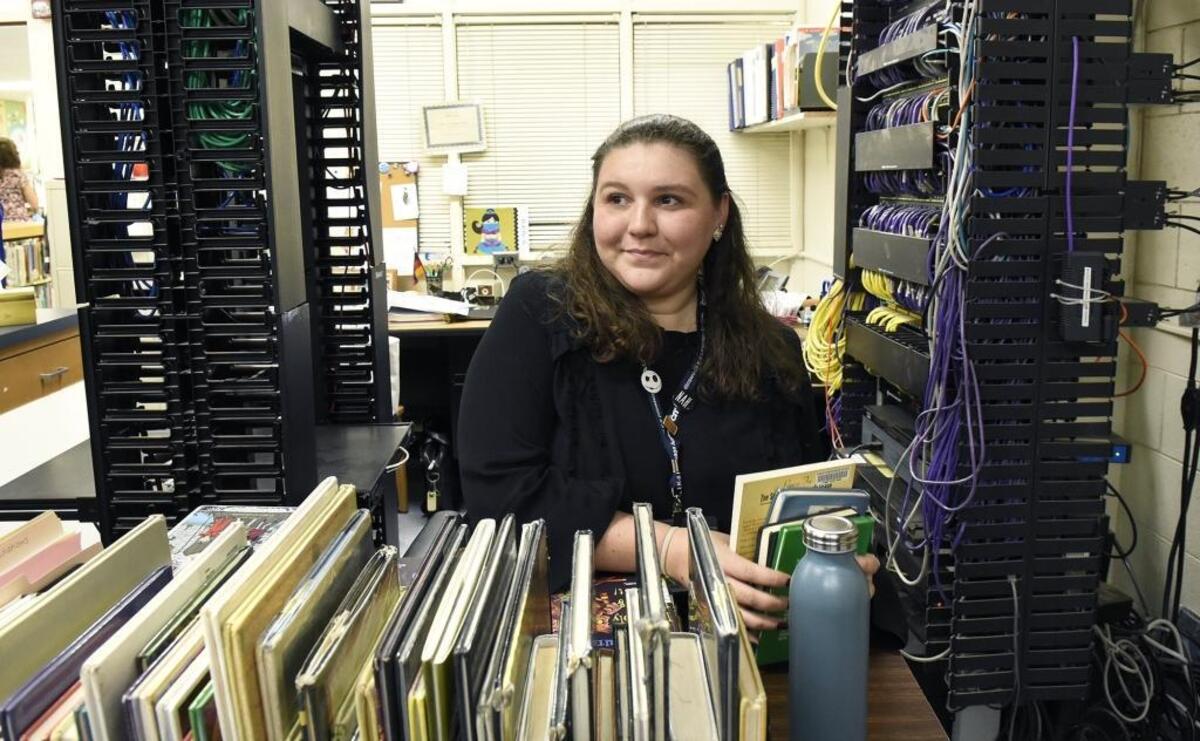 Mariana Duran, a Collinswood media center assistant, has her desk wedged between the school’s computer servers and beneath an air-conditioning unit. She and two other staffers have makeshift offices in this small room off the media center.