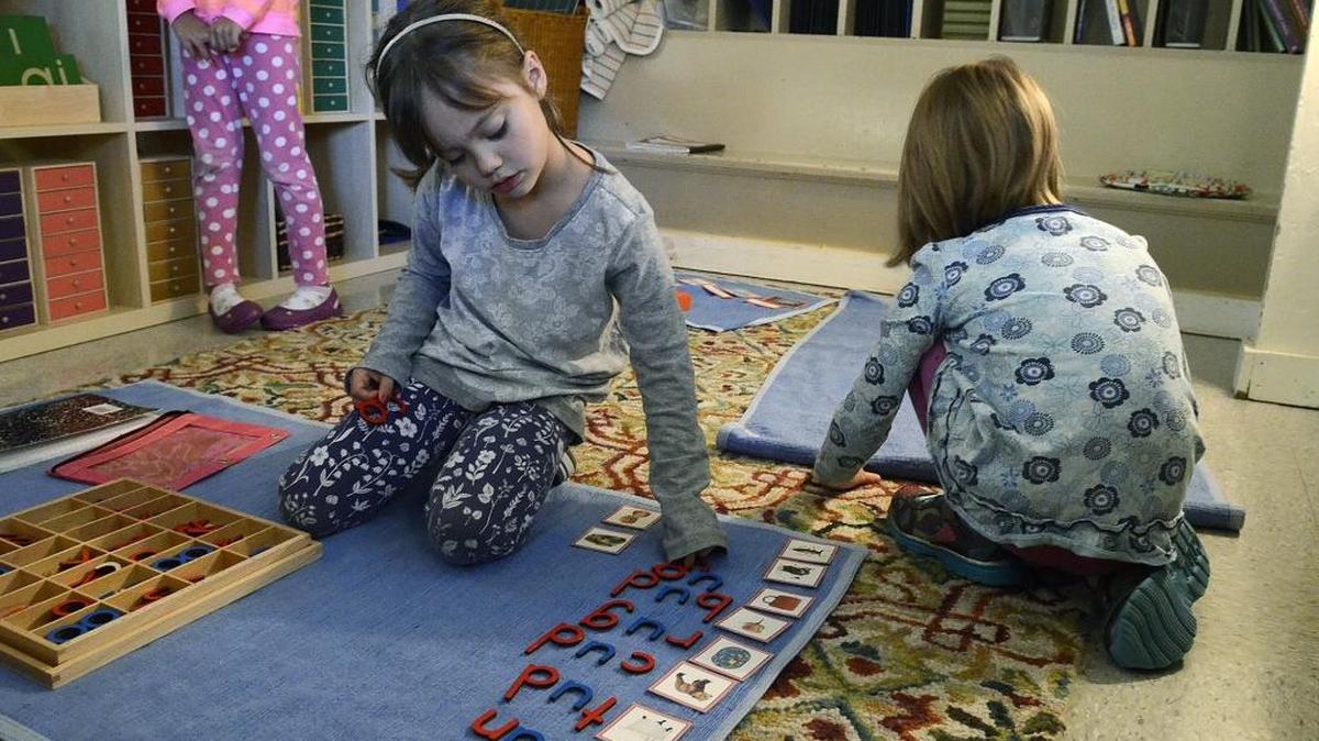 Students at Park Road Montessori School line up pictures and spell words in the class for 4- and 5-year-olds.