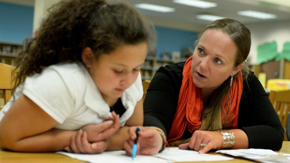 Communities in Schools Site Coordinator Anna Kennington tutors student Valery Granobles, 10, at Winterfield Elementary School.