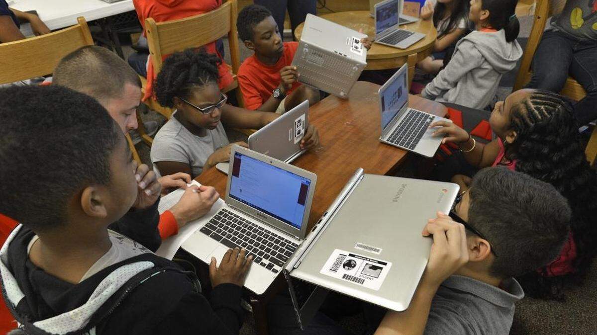 
Sixth-graders check out their new laptops at Piedmont Middle School, an uptown CMS magnet that got a new A+ rating.

